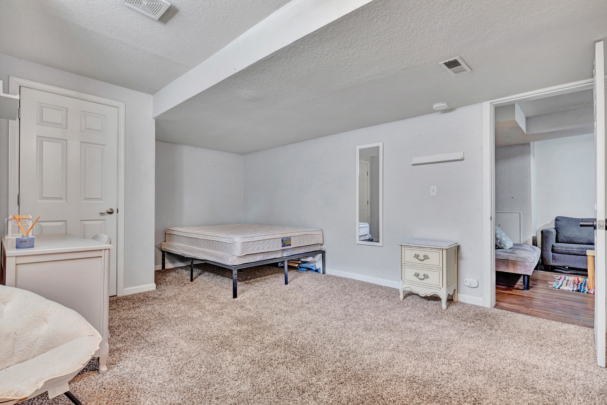 Carpeted bedroom opening to the lower living area