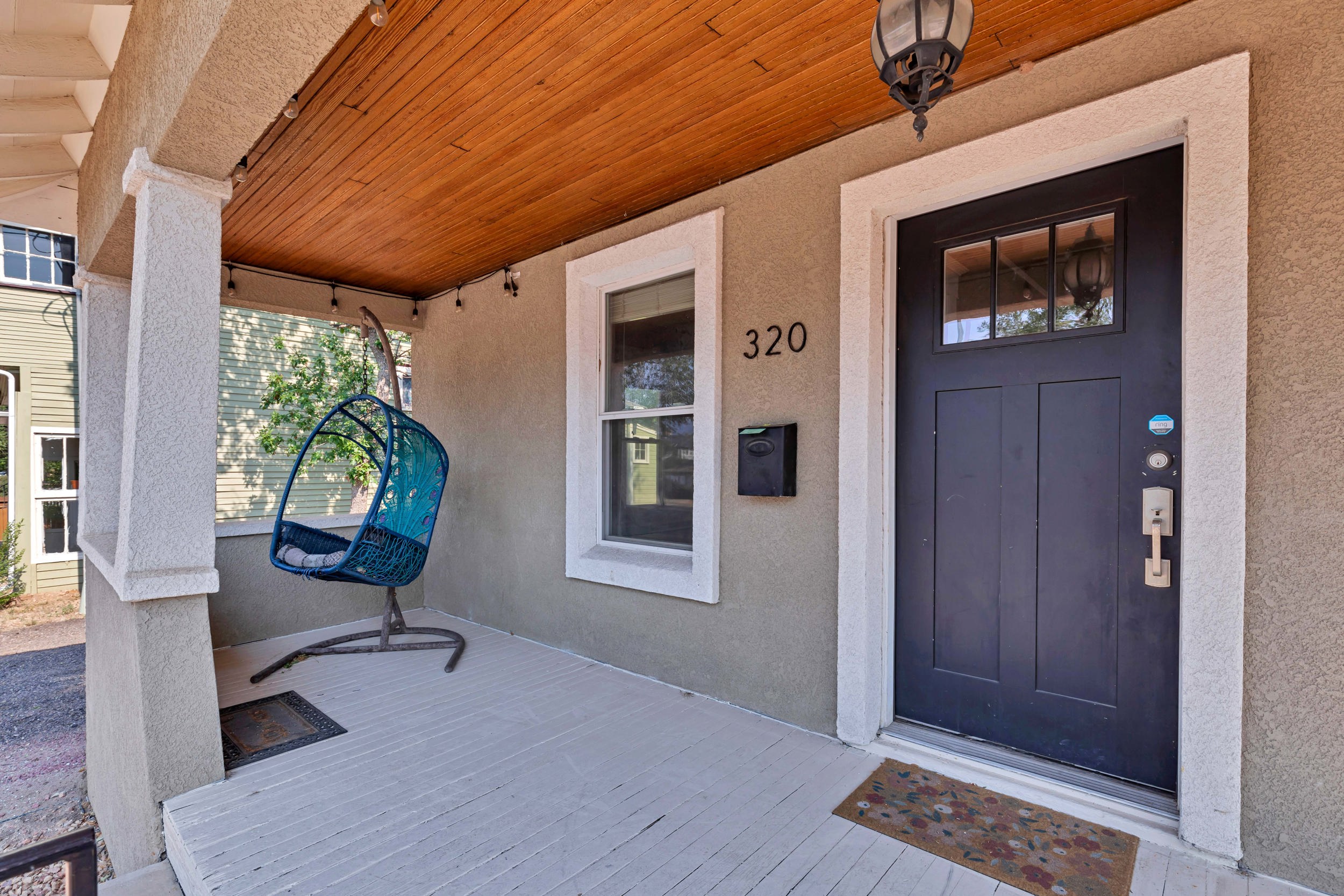 Covered front porch with hanging chair